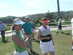 The group watches the first 4 ball Tee off